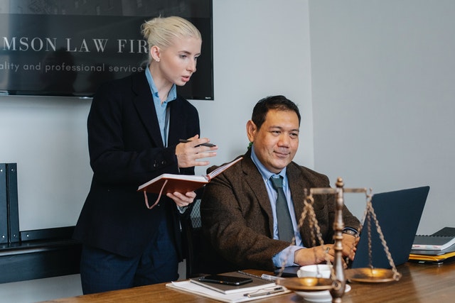 two lawyers working next to a table